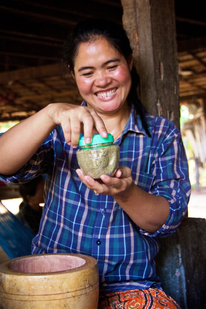 A Cambodian entrepreneur prepares her small fish powder for sale.